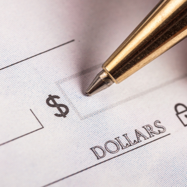 Someone about to write a money amount on a check