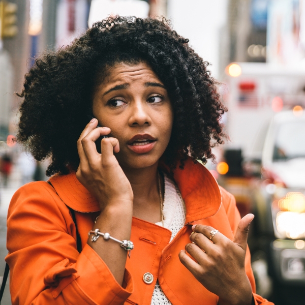 A women on the phone with an ambulance in the background