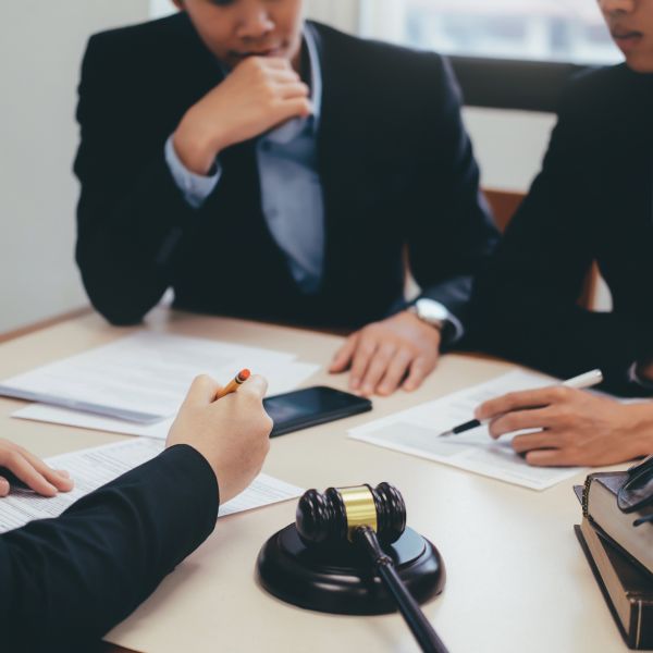Three attorneys discussing a document