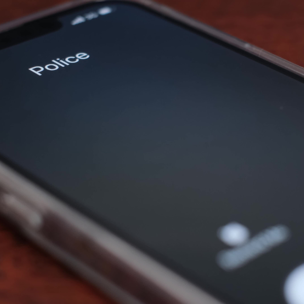 A person receiving a phone call from the police