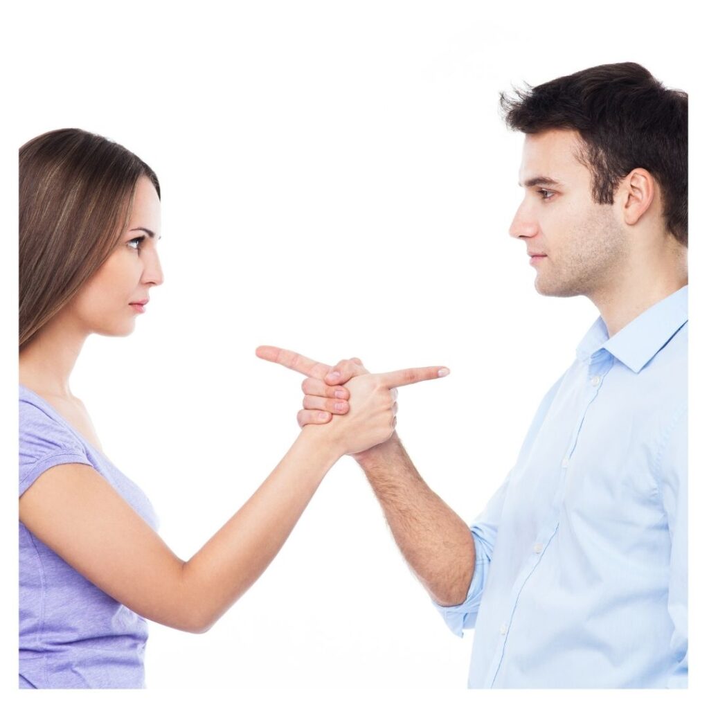 Two people pointing at each other