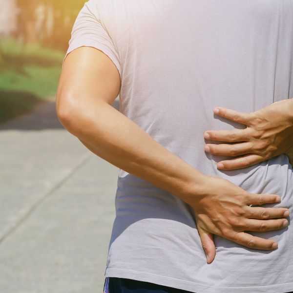 Someone grabbing their back in pain