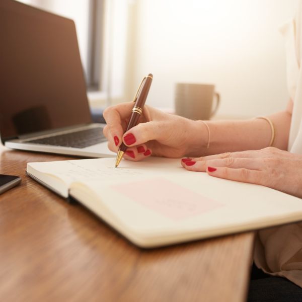 A person writing in a journal