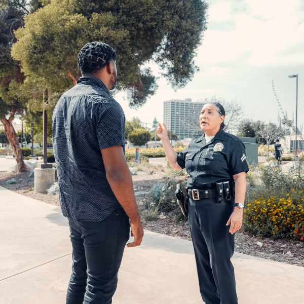 A man speaking to a police officer