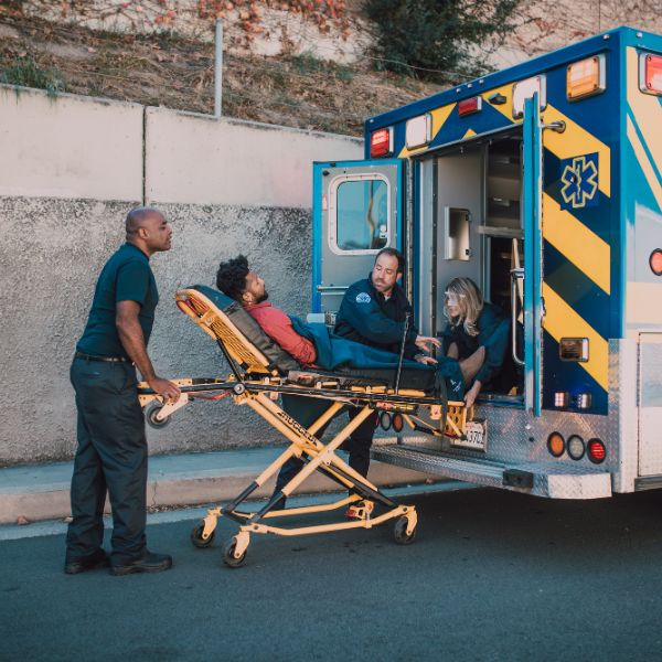 A man being placed into the back of a hospital