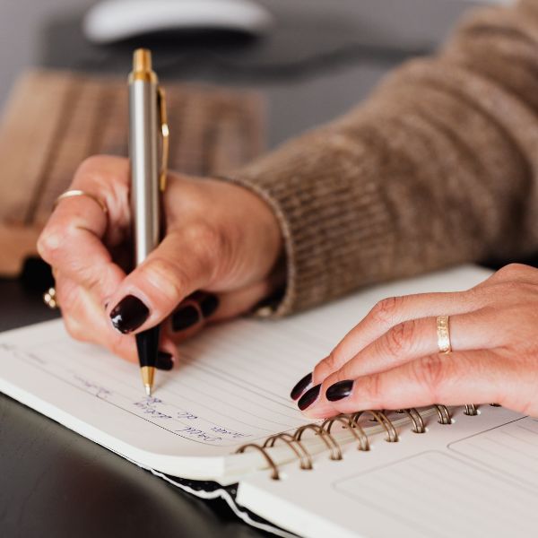 A person writing in a journal