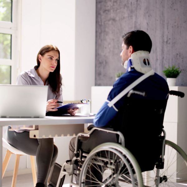 An injured man speaking to a woman
