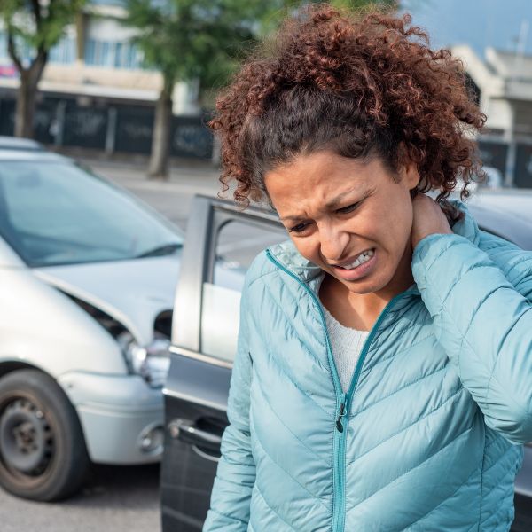 Mujer agarrándose el cuello por el dolor