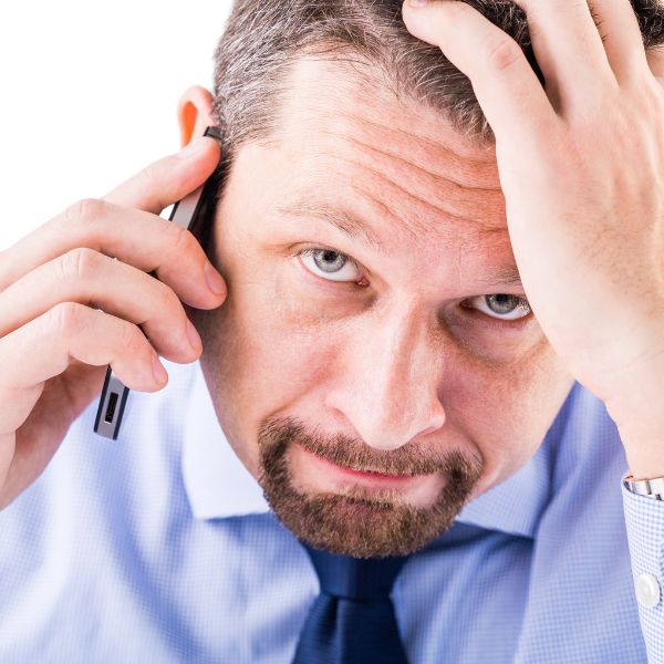 A frustrated man speaking on the phone