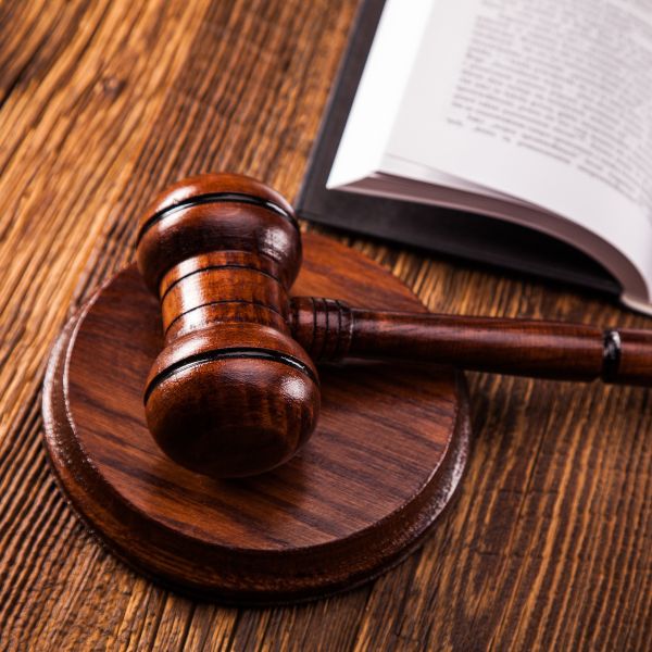 A judge gavel next to a law book