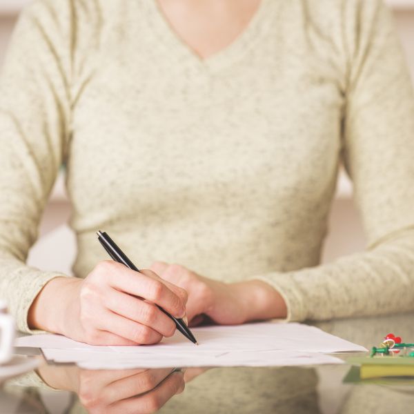 A woman writing stuff down