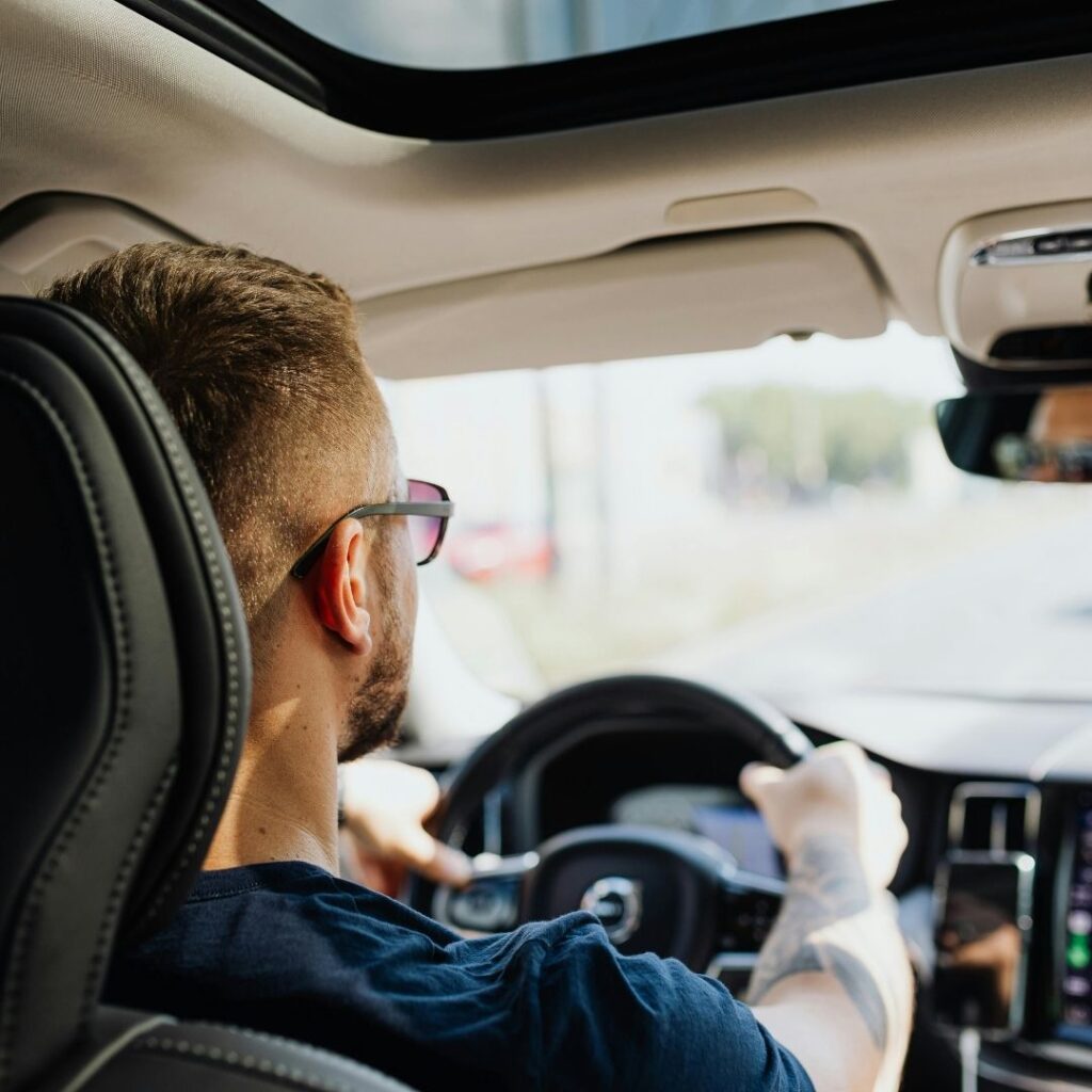 A person with both hands on the steering wheel