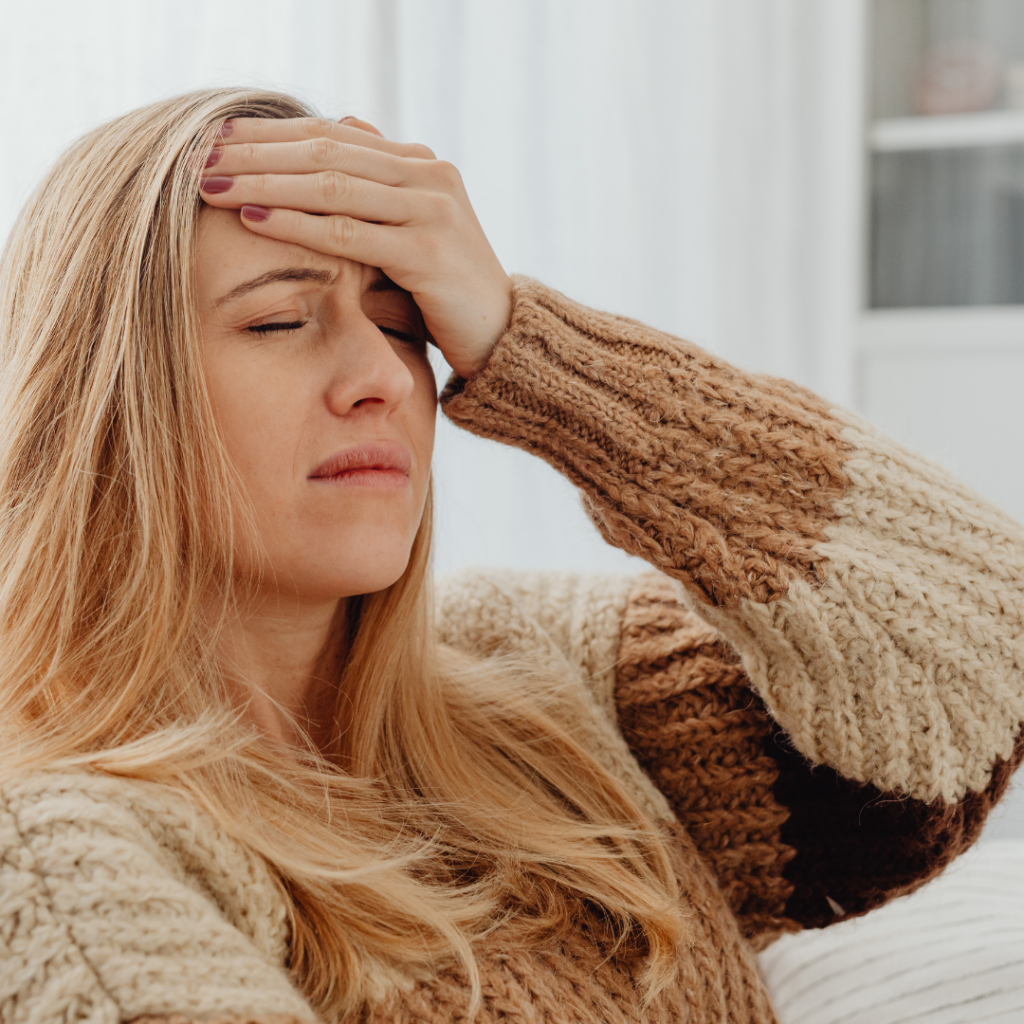 Woman grabbing her head in pain