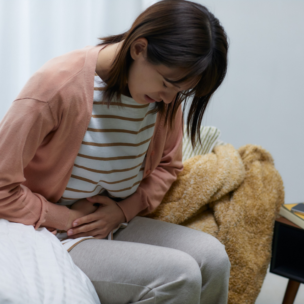 Woman grabbing stomach in pain