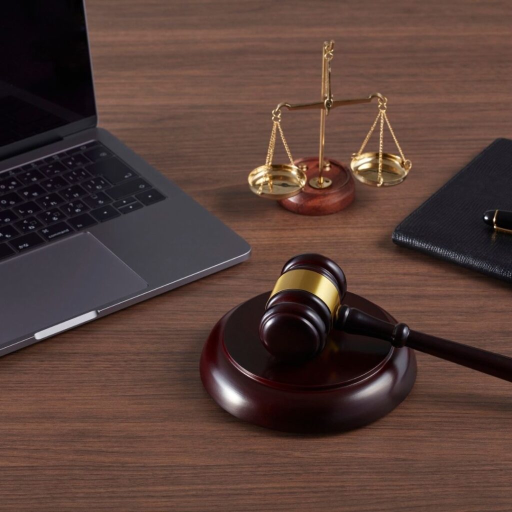 A judge gavel next to a laptop